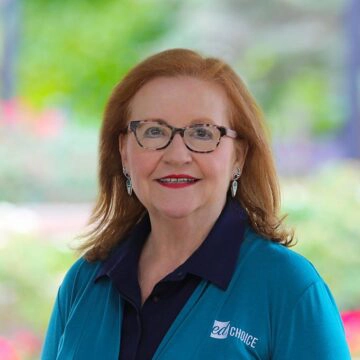 Woman wearing a teal shirt smiling